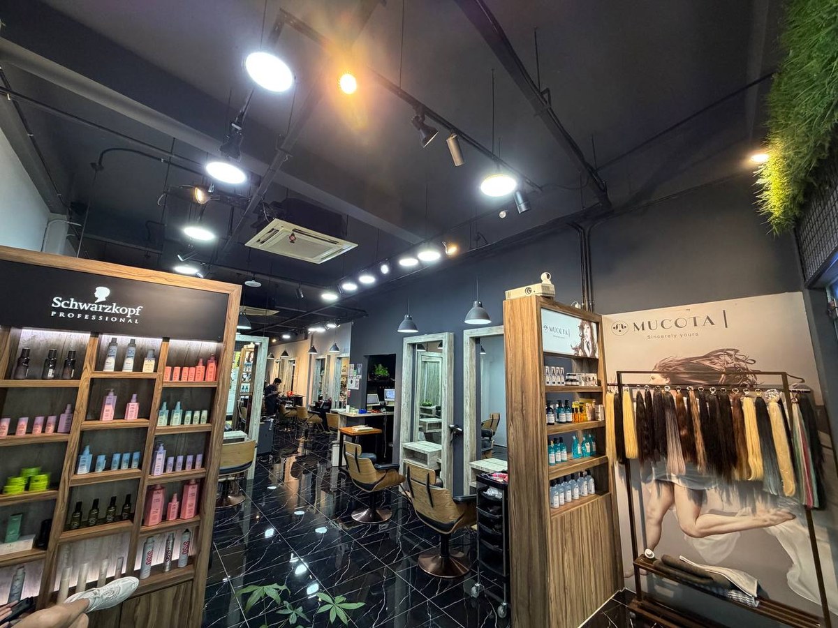Inside Bazaar Hair Salon at 516 Geylang Road: black marble floors, styling chairs, Schwarzkopf Professional shelves and a wall of hair extension swatches.