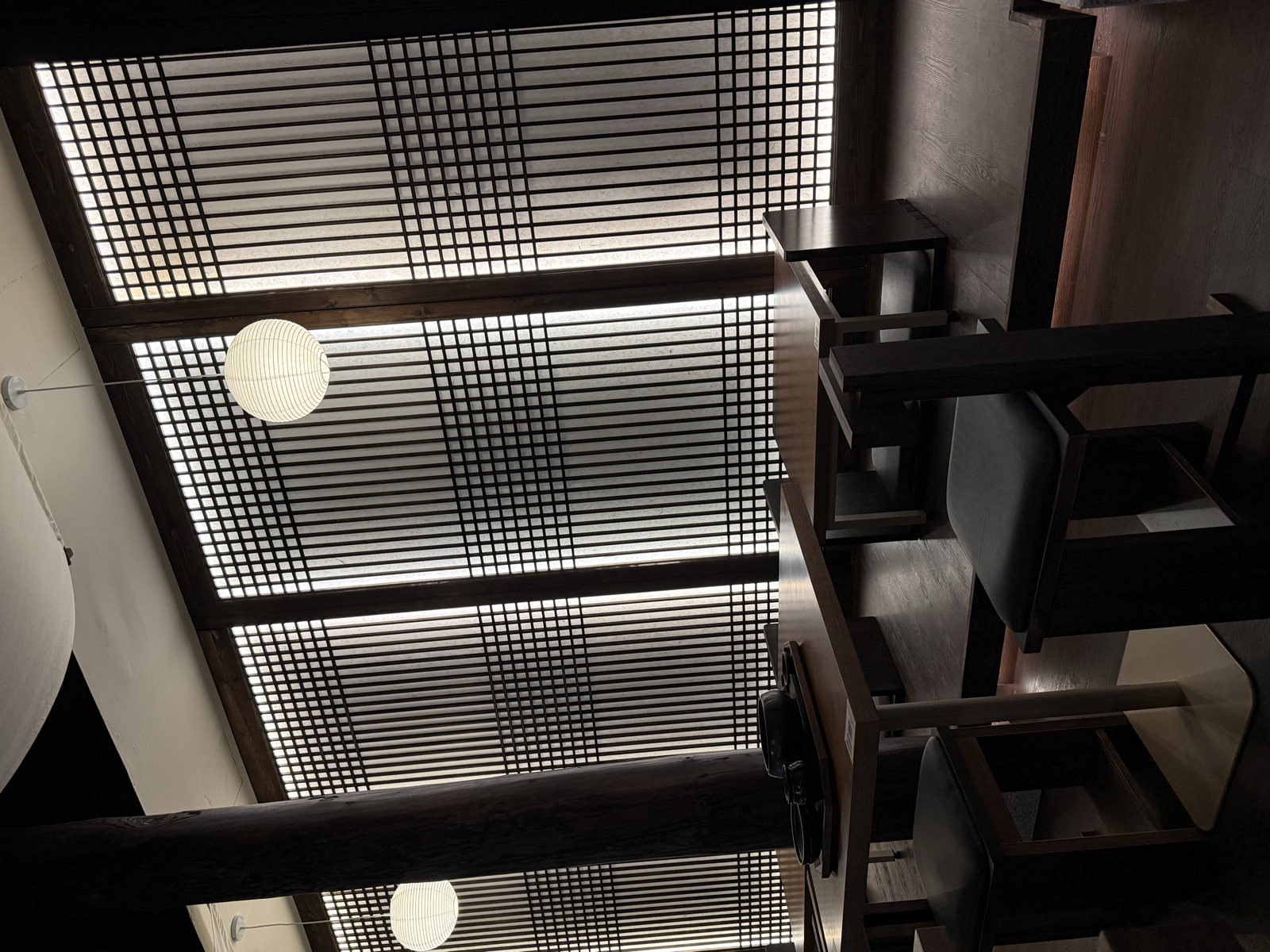 Onggii Novena Square 2 dining room: latticed hanok screens backlit through hanji paper, dark timber columns and paper lanterns.