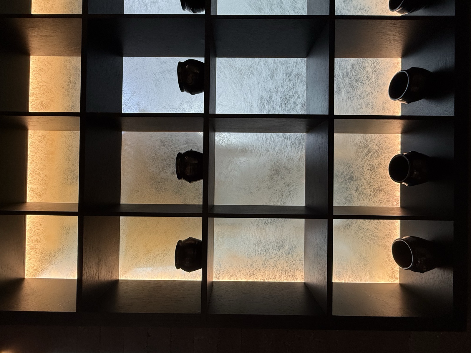 Backlit display shelf of traditional onggi earthenware pots at Onggii Novena Square 2.