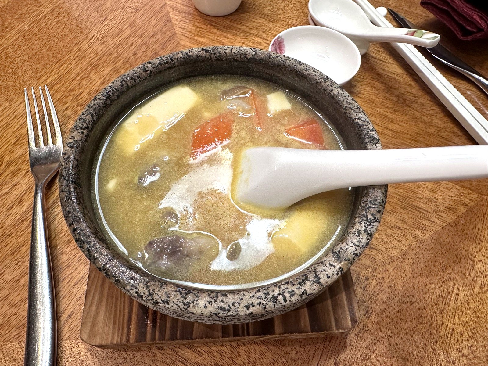 Stone pot of grass carp fillet soup with papaya at Xin Cuisine.